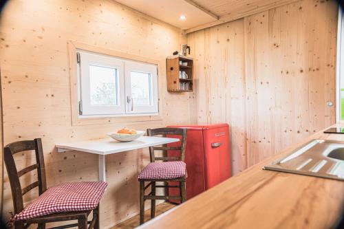 a kitchen with a small table and a red refrigerator at Tiny-Haus im Südhessischen Ried in Trebur