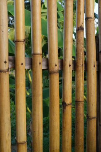 a close up of a bamboo fence at Suku Lifestyle Hotel & Villas in Selong Belanak