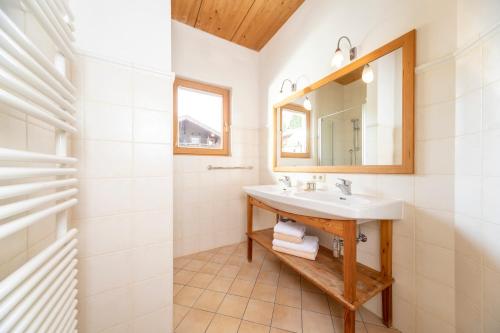 a bathroom with a sink and a mirror at Gästehaus Larch in Alpbach