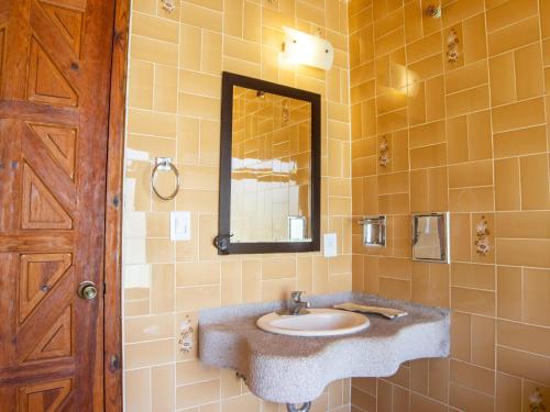 ein Bad mit einem Waschbecken und einem Spiegel in der Unterkunft Valle Dorado in Valle de Bravo