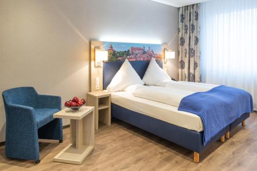Postel nebo postele na pokoji v ubytování Ringhotel Loew's Merkur