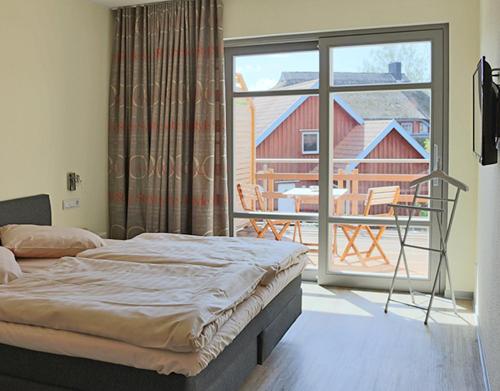 En eller flere senge i et værelse på Fischerhaus Plau am See