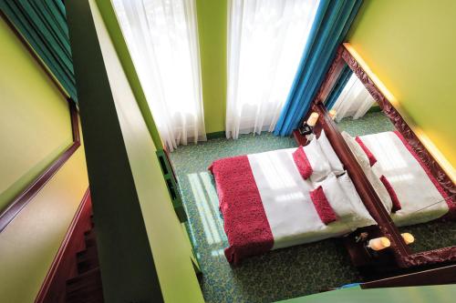an overhead view of a bedroom with a bed with a mirror at Domina St.Petersburg in Saint Petersburg