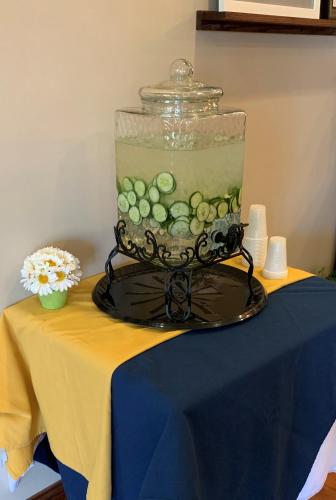 a glass jar filled with green balls in a bowl on a table at Country Inn & Suites by Radisson, Ithaca, NY in Ithaca