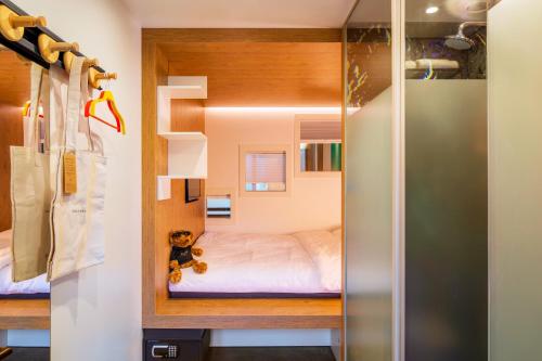 a small bedroom with a bed in a tiny house at BUNK Hotel Utrecht in Utrecht