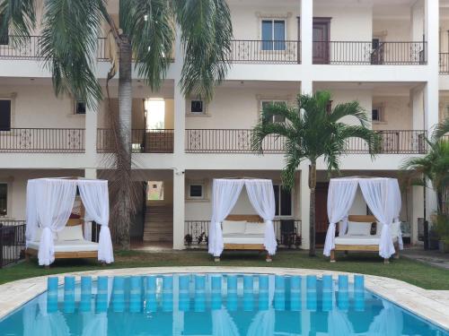 a hotel with a pool in front of a building at Bavaro Green in Punta Cana