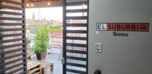 a door to a room with a view of a building at El Suburbio - Morelos Sur in Morelia