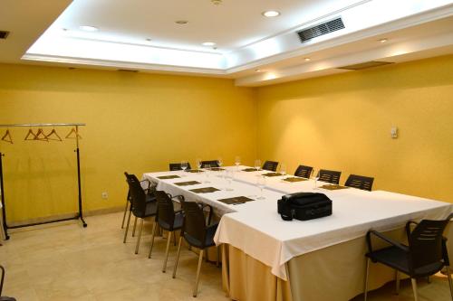 a conference room with a long table and chairs at Hotel Alda San Carlos in Santiago de Compostela