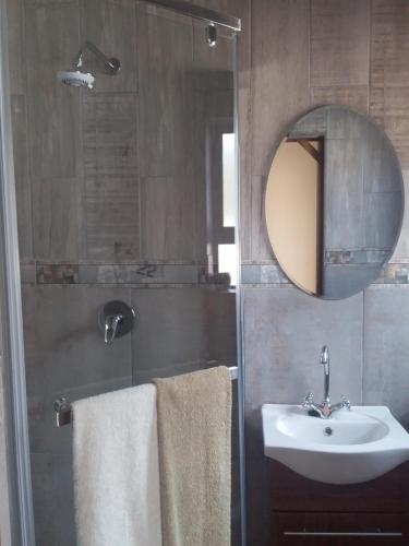 a bathroom with a sink and a mirror at Trianca guest house in Welkom
