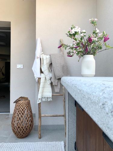 a kitchen with a counter with a vase of flowers at Pr' Kramarju - House in the heart of Kobarid in Kobarid