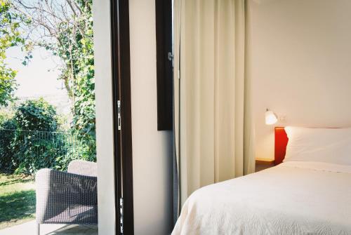 a bedroom with a bed and a window at Giardino Sul Duomo in Ragusa