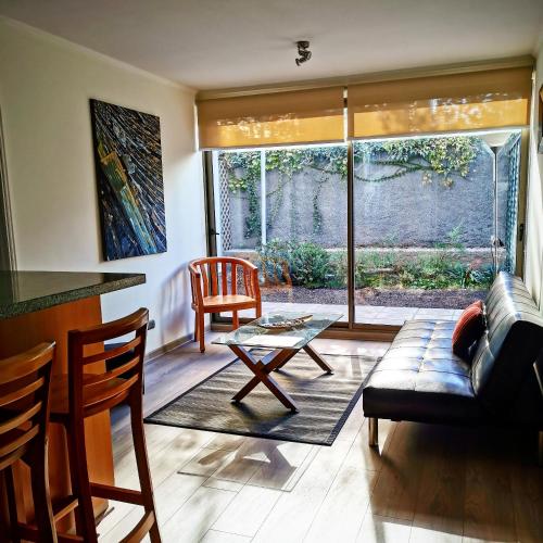 a living room with a couch and a table at Apart Hotel Viva Providencia in Santiago