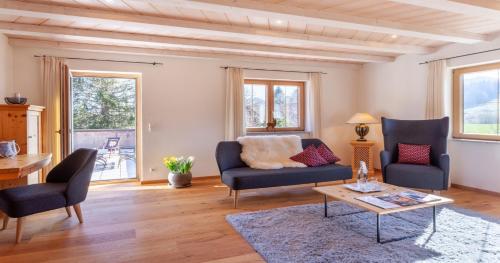 a living room with two chairs and a table at Hotel Natur-Landhaus Krone in Maierhöfen
