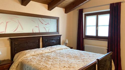 a bedroom with a large bed and a window at Nel Verde in Villar San Costanzo