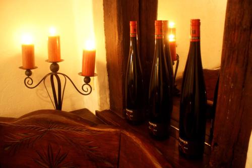 a bunch of wine bottles in a wall with candles at Hotel Weingärtner in Mannheim