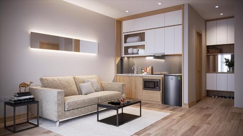 a living room with a couch and a kitchen at Fukurai Hotel & Apartment 2 Ha Noi in Hanoi