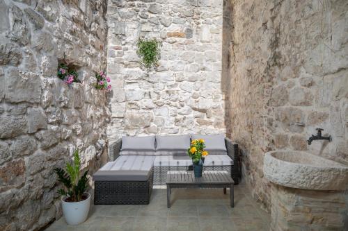 a patio with a bench and a sink at Awesome Stone House in Split