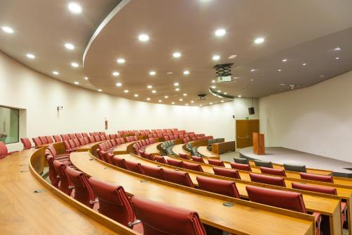 an empty lecture hall with red chairs and a stage at PortAventura Hotel PortAventura - Includes unlimited access to PortAventura Park & 1 access to Ferrari Land in Salou