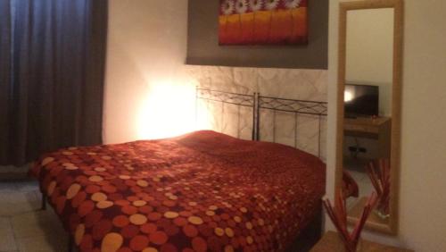 a bedroom with a bed with a red comforter at Bed and Breakfast Top Class in Bari