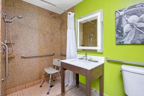 a bathroom with a sink and a shower and a toilet at La Quinta by Wyndham Visalia/Sequoia Gateway in Visalia
