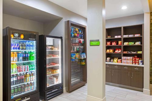 a store with two large refrigerators and drinks at La Quinta by Wyndham Visalia/Sequoia Gateway in Visalia