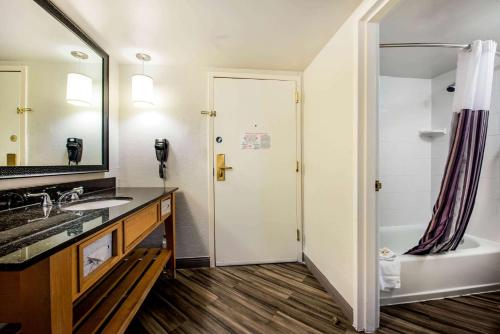 a bathroom with a tub and a sink and a shower at La Quinta by Wyndham Fort Lauderdale Tamarac in Fort Lauderdale