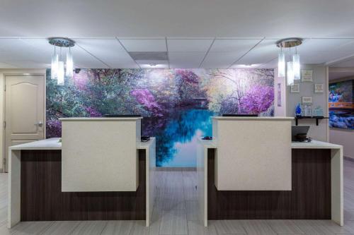a lobby with a large painting on the wall at La Quinta by Wyndham Effingham in Effingham