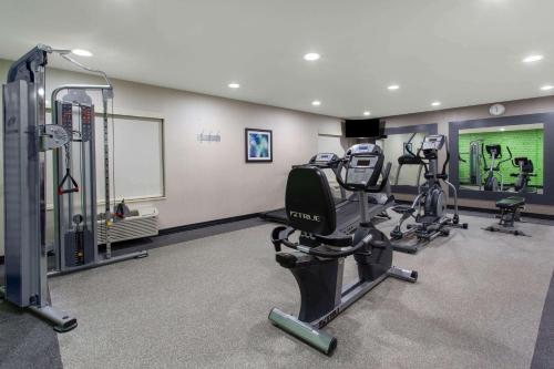 a gym with several tread machines in a room at La Quinta by Wyndham Effingham in Effingham