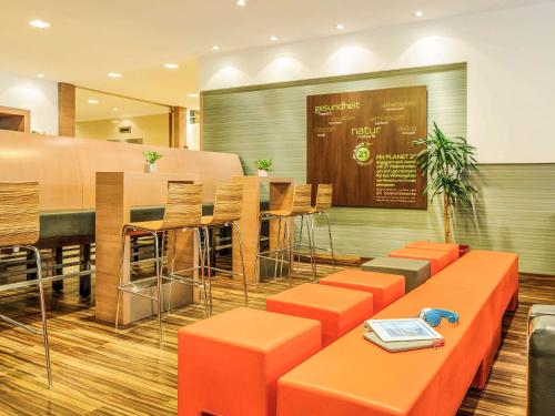 a living room filled with furniture and decor at Ibis Wien Mariahilf in Vienna