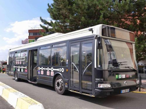 a black bus is driving down the street at ibis Styles Paris Roissy-CDG in Roissy-en-France