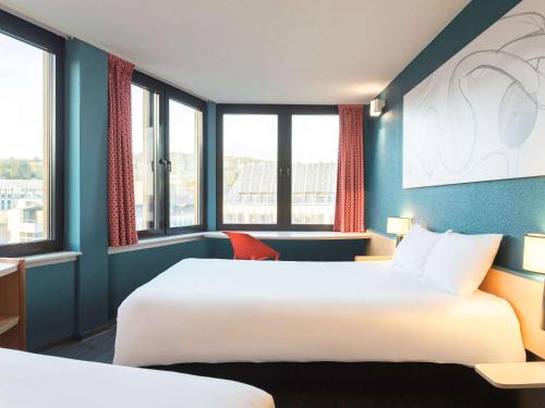 Postel nebo postele na pokoji v ubytování ibis Liège Centre Opéra