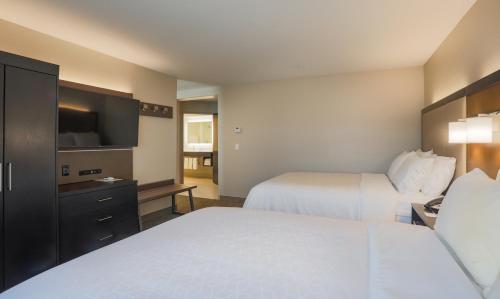 a hotel room with two beds and a flat screen tv at Holiday Inn Express Prescott by IHG in Prescott