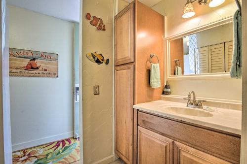 a bathroom with a sink and a mirror at First Responders Book With Us - Kona Islander Inn! in Kailua-Kona
