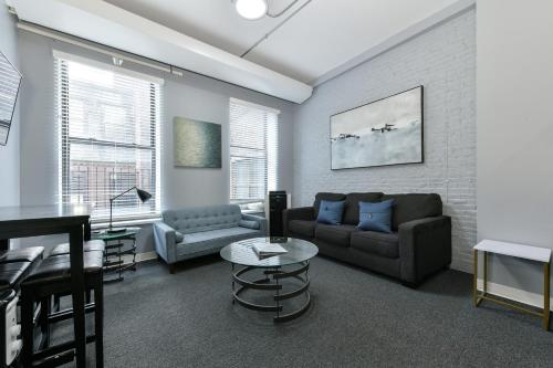a living room with a couch and a table at Temple Place Suites in Boston