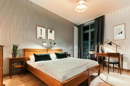 a bedroom with a bed and a desk and a window at Hotel Esplanade in Gmunden