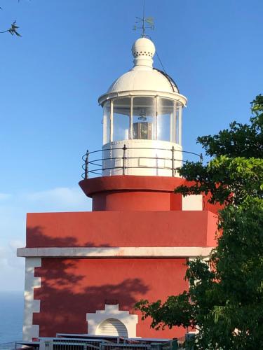 a red and white lighthouse on top of a building at Villa belle lune in La Trinité