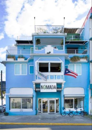a blue building with two bikes in front of it at Nomada Urban Beach Hostel- Calle Loiza in San Juan