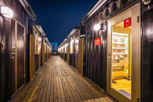 an empty hallway of a store at night at HOTEL R9 The Yard Sanotenjin in Sano