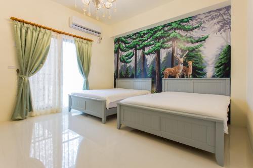 a bedroom with two beds and a painting of giraffes at When Happiness Knock your Door in Hualien City