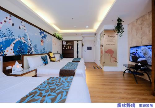 a hotel room with two beds and a tv at 85 Asia Hotel in Kaohsiung