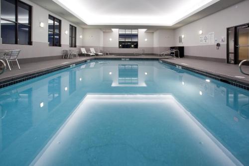 een groot zwembad met blauw water in een gebouw bij Holiday Inn Express Hotel & Suites Rock Springs Green River, an IHG Hotel in Rock Springs