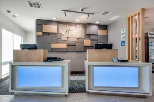 two blank screens in an office lobby at Holiday Inn Express & Suites Dallas North - Addison by IHG in Addison