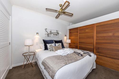 a bedroom with a large bed and a ceiling fan at Premium 1BR Apartment at Princes Wharf in Auckland