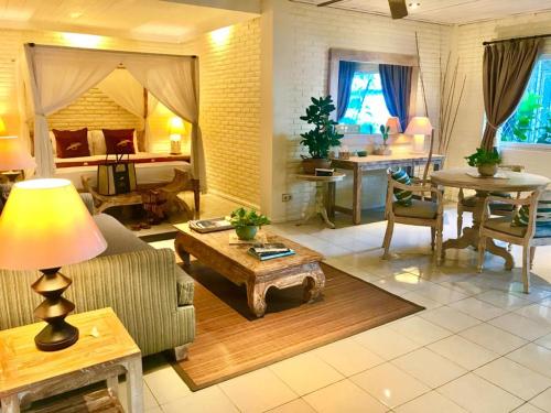 a living room with a couch and a table at Tauch Terminal Resort Tulamben & Spa in Tulamben