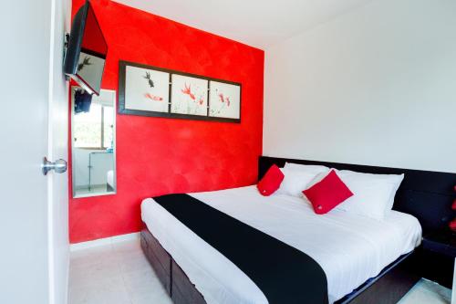 a red bedroom with a bed with red walls at Quinta Santa Anita in Playa del Carmen