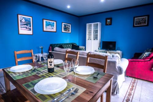 a dining room with a table and a couch at Apartaments Yaco in Lloret de Mar