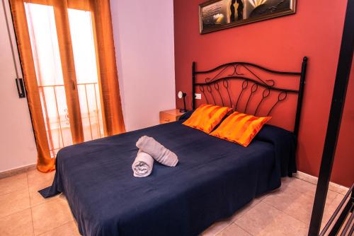 a bedroom with a bed with a hat on it at Apartaments Yaco in Lloret de Mar