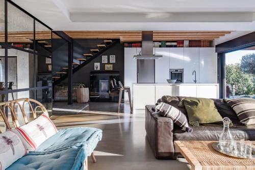 a living room with a couch and a table at Luxury Villa Beach & Golf in San Juan de Alicante