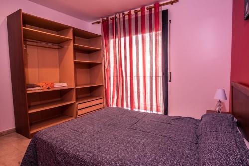 a bedroom with a bed and a large closet at Apartaments Yaco in Lloret de Mar