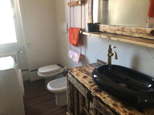 a bathroom with a black sink and a toilet at ATTIC HOUSE - IL TUO ATTICO A RAPALLO in Rapallo
